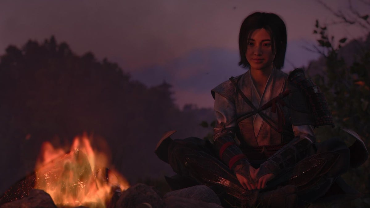 Naoe looks at a campfire in Assassin's Creed Shadows